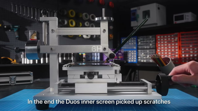 HTX Studio's pencil scratch-test rig applying a 6H pencil to iPhone Duo's inner screen